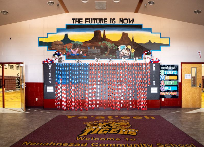 The future is now mural painted on wall above entrance to gym