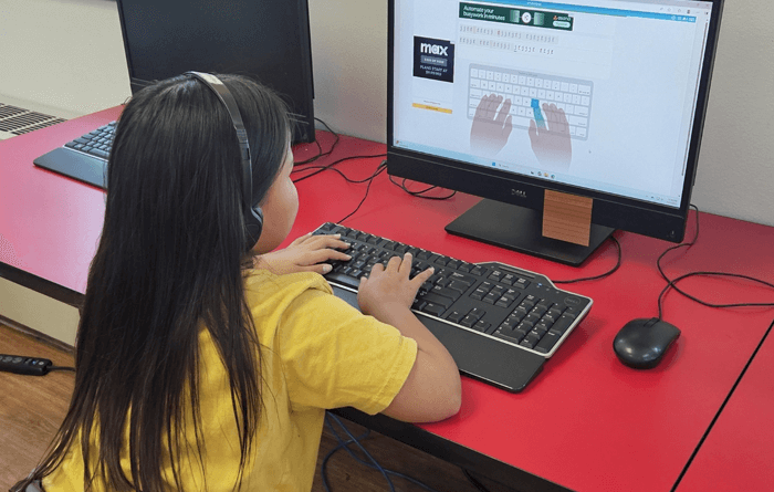 Young daughter working on a computer