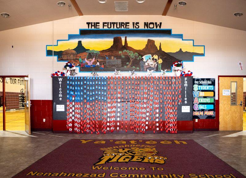The future is now mural painted on wall above entrance to gym